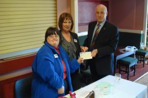 Sarah and Halan receive the cheque from Richard Stackhouse, Chairman of our Community Service and Vocational Committee